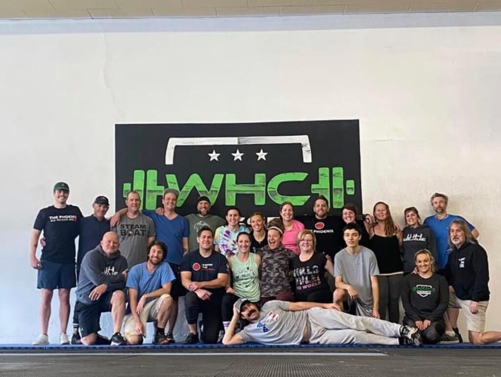 People lined up for a Picture in front of WHC Poster